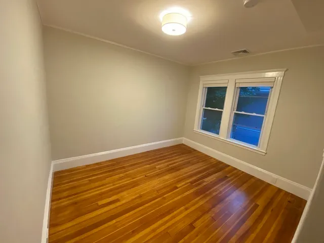 a view of room with wooden floor