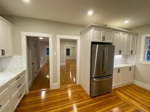 a room with a bed and cabinets