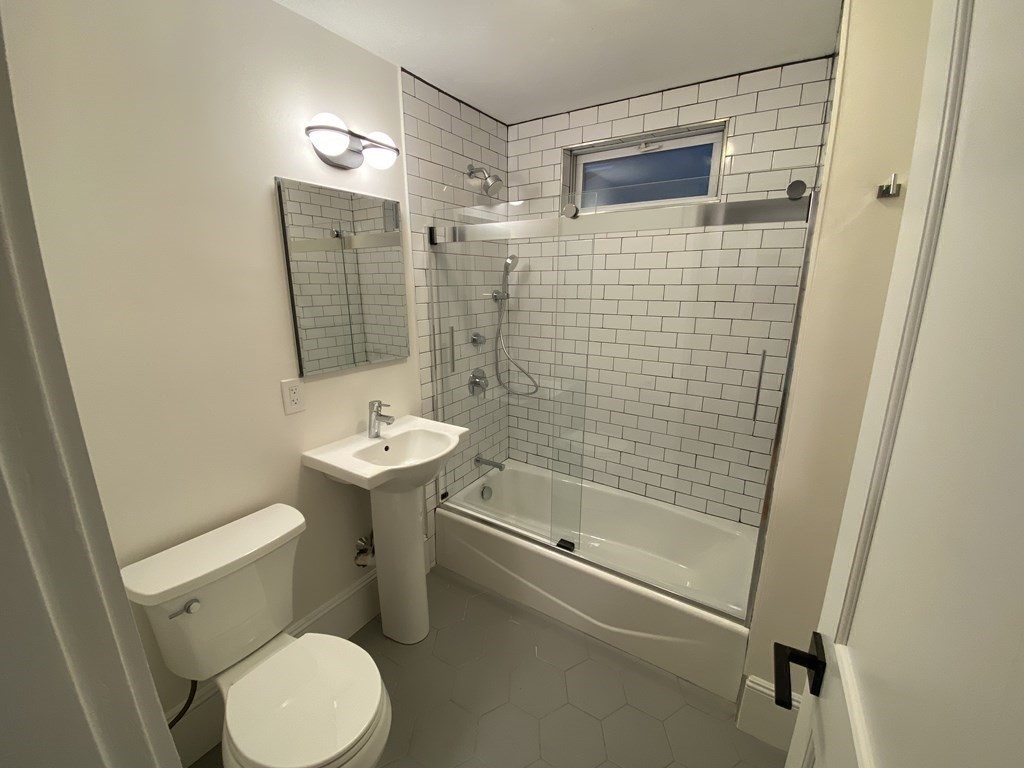 26 Playstead Road, Unit 2 Newton, MA 02458 - Photo 21 of 27 a bathroom with a sink a toilet and shower