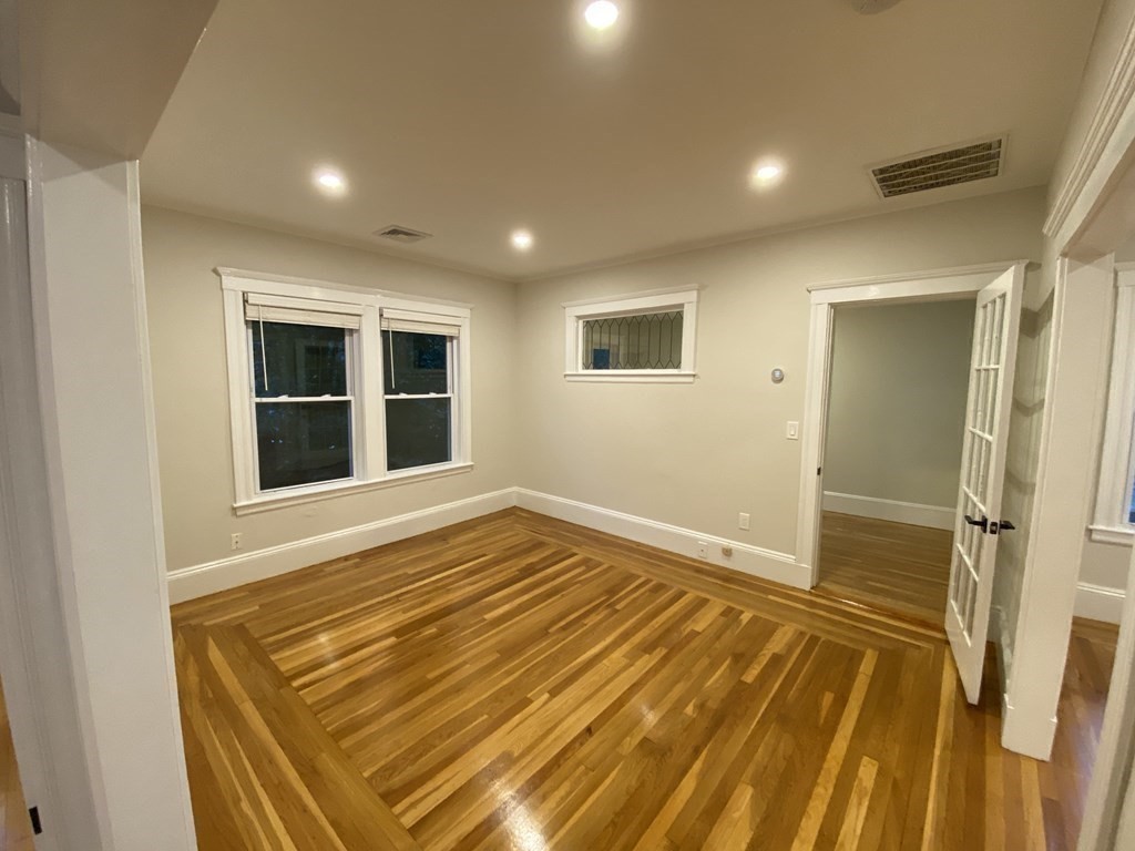 26 Playstead Road, Unit 2 Newton, MA 02458 - Photo 4 of 27 a view of an empty room with wooden floor and a window