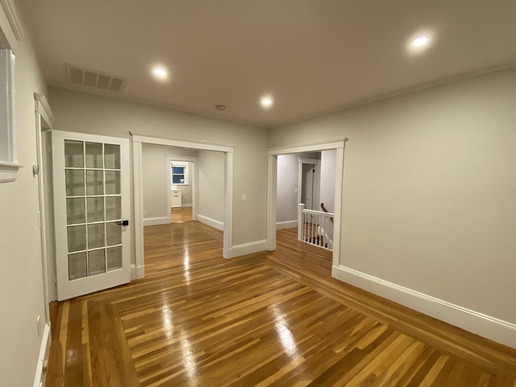 26 Playstead Road, Unit 2 Newton, MA 02458 - Photo 6 of 27 en empty room with wooden floor and windows