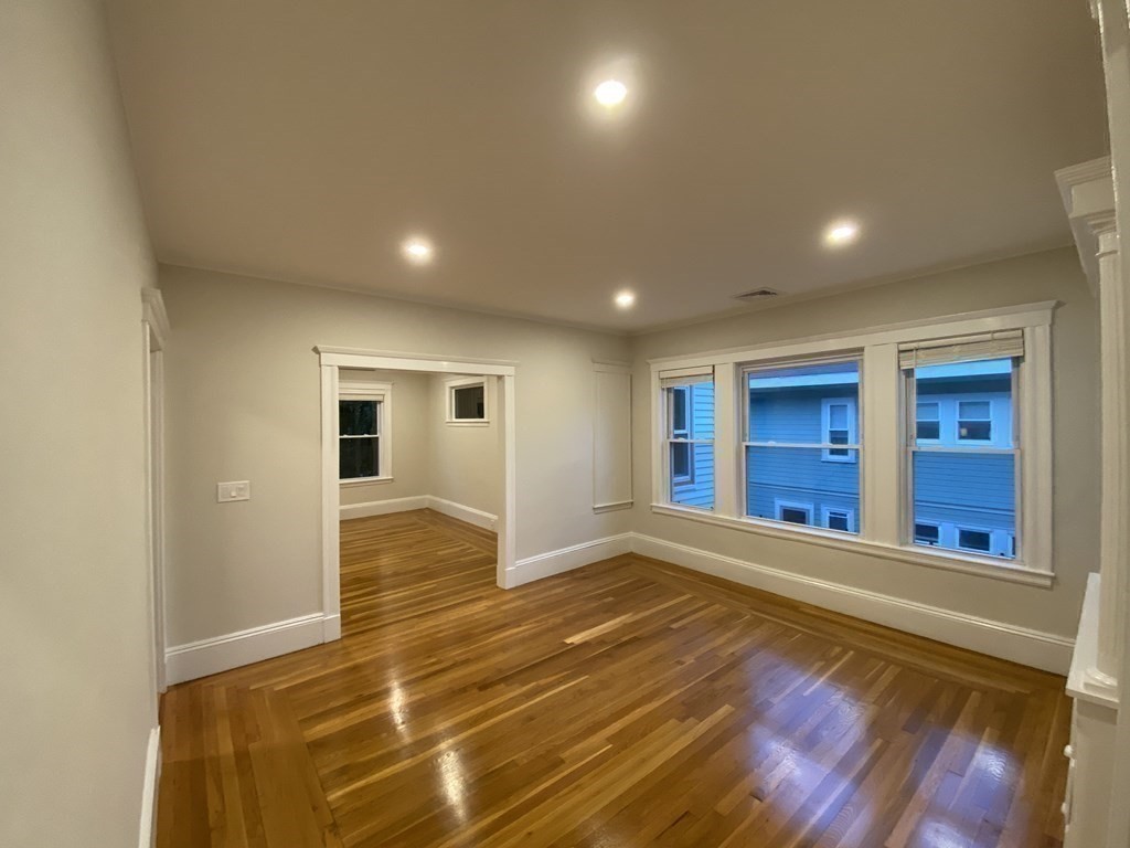 26 Playstead Road, Unit 2 Newton, MA 02458 - Photo 8 of 27 a view of an empty room with wooden floor and windows
