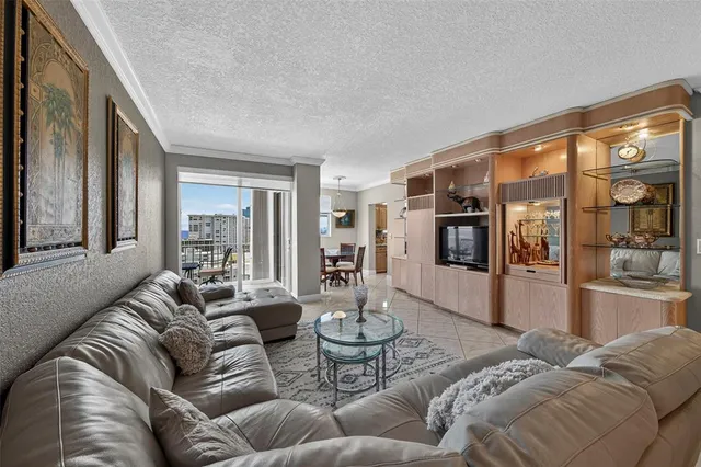 a dining room with furniture a chandelier and a rug