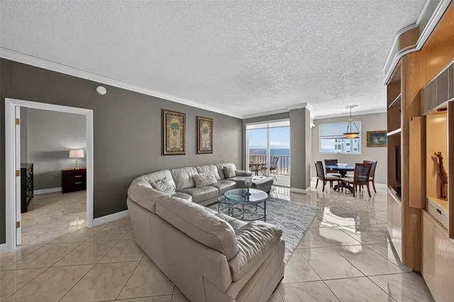 a view of a dining room with furniture a chandelier and window