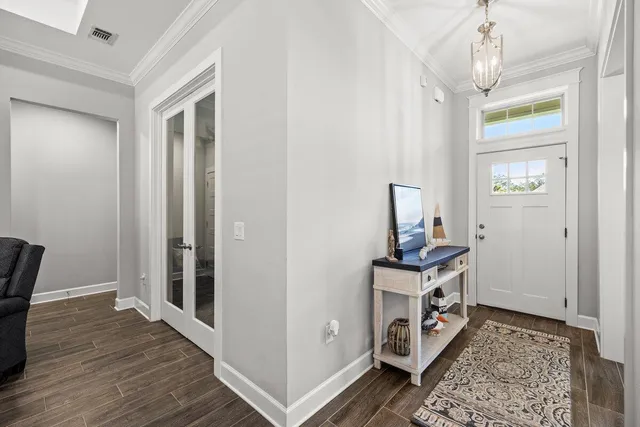 a en suite bathroom with a granite countertop double vanity sink a mirror and a shower