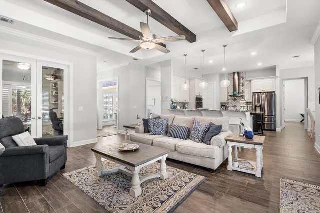 a view of a a dining room with furniture window and wooden floor