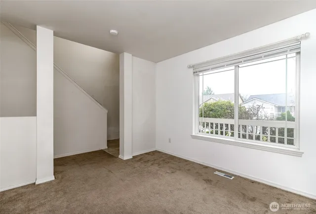 a view of an empty room with a window