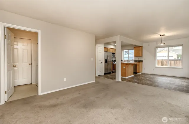 an empty room with windows and cabinet