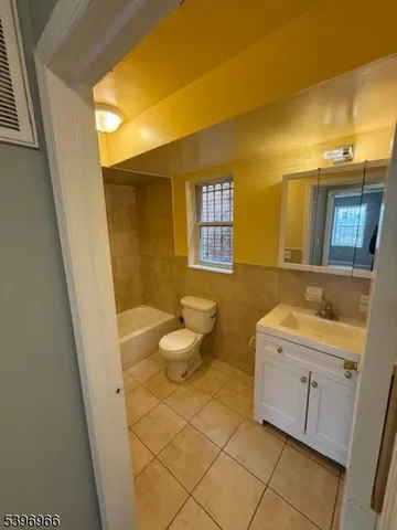 a bathroom with a sink a toilet and a tub