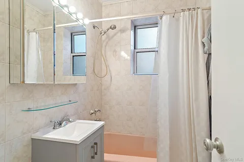 a bathroom with a sink a mirror and a shower