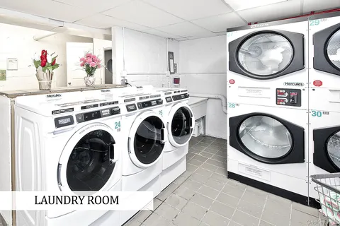 a view of a storage and utility room with dryer and washer