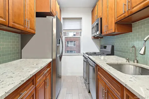 a kitchen with a sink and a refrigerator