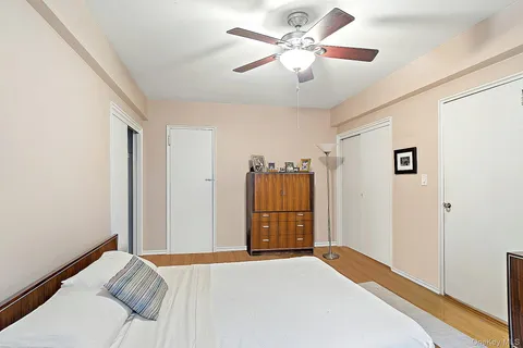 a bedroom with a large bed and a chandelier