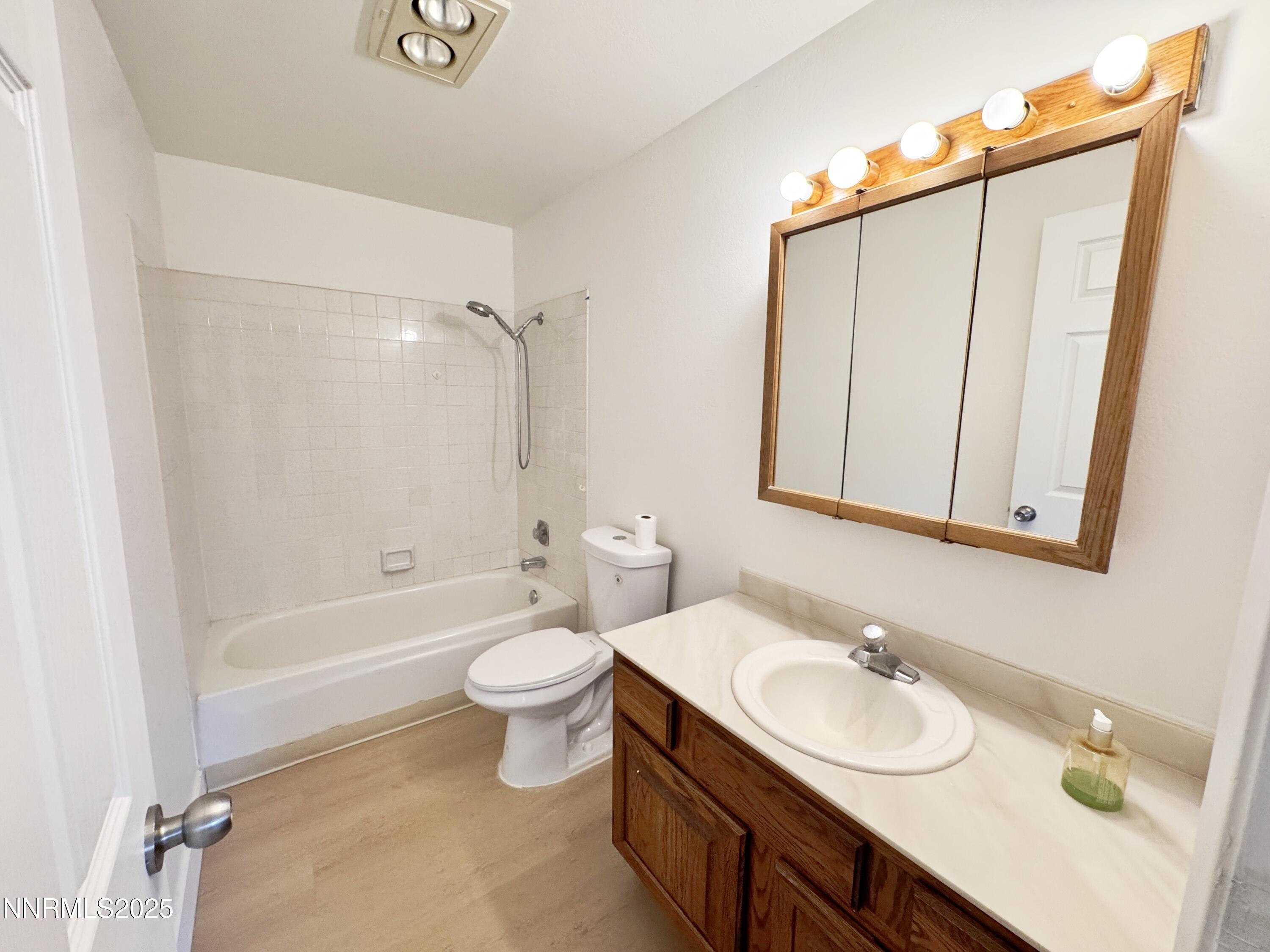 4205 Santa Maria Drive Reno, NV 89502 - Photo 13 of 23 a bathroom with a sink toilet a mirror and shower