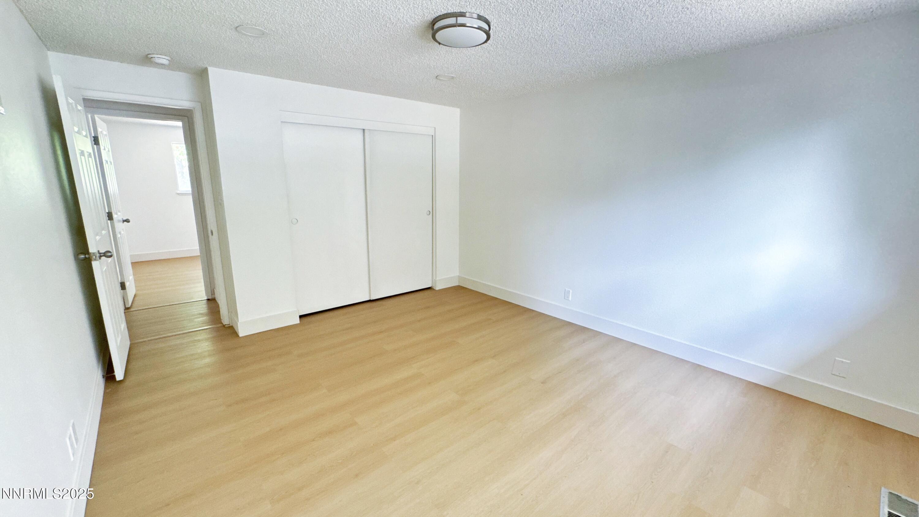 4205 Santa Maria Drive Reno, NV 89502 - Photo 17 of 23 an empty room with wooden floor and mirror