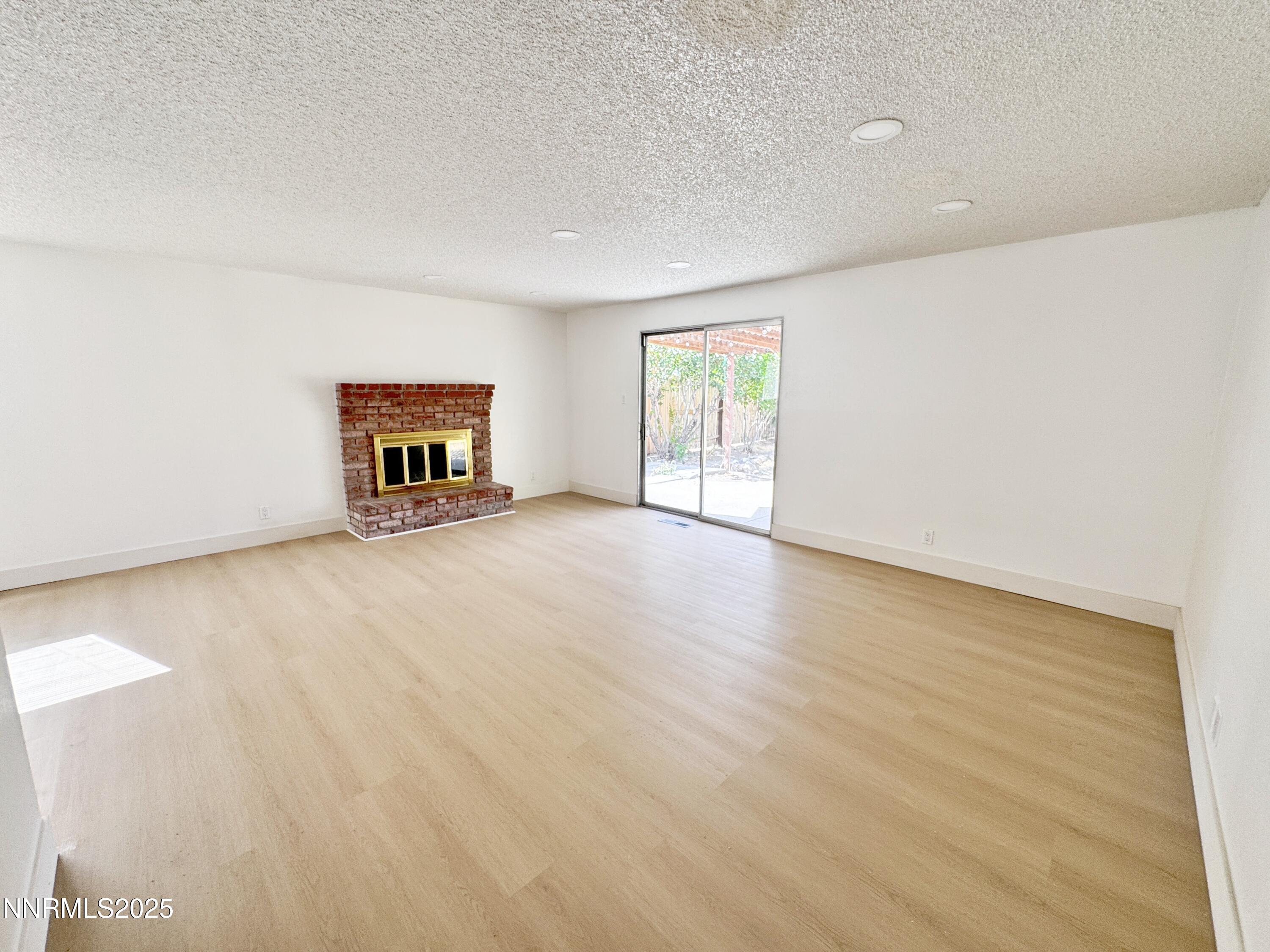 4205 Santa Maria Drive Reno, NV 89502 - Photo 7 of 23 a view of an empty room with a window and wooden floor