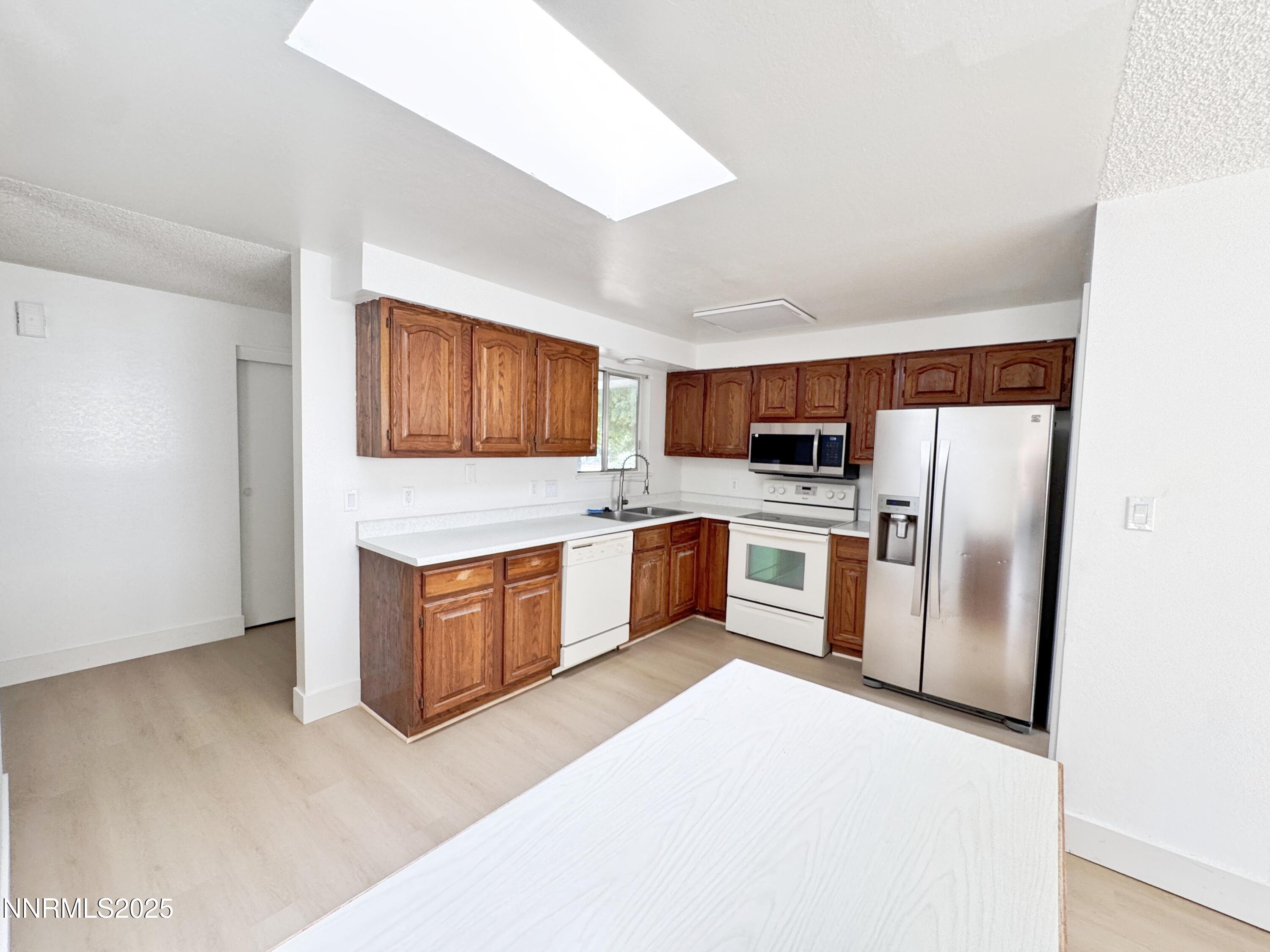 4205 Santa Maria Drive Reno, NV 89502 - Photo 10 of 23 a large kitchen with stainless steel appliances granite countertop a refrigerator a stove a sink and a microwave