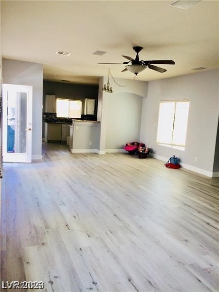 8897 Houston Ridge Avenue Las Vegas, NV 89178 - Photo 12 of 12 An open floorplan seamlessly connects the living space to the kitchen, highlighted by new light-toned flooring.