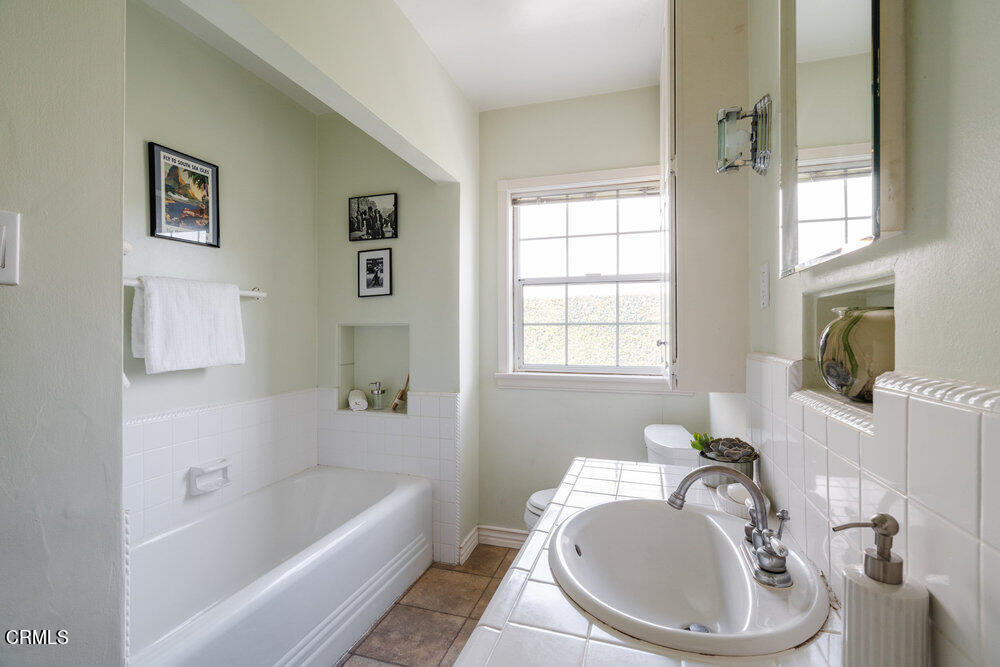 1795 Sonoma Drive Altadena, CA 91001 - Photo 16 of 29 a bathroom with a tub a sink and a window