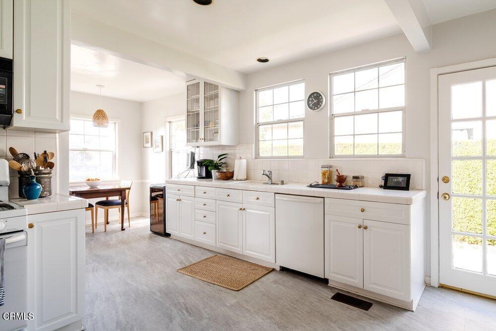 1795 Sonoma Drive Altadena, CA 91001 - Photo 8 of 29 a kitchen with white cabinets and a window