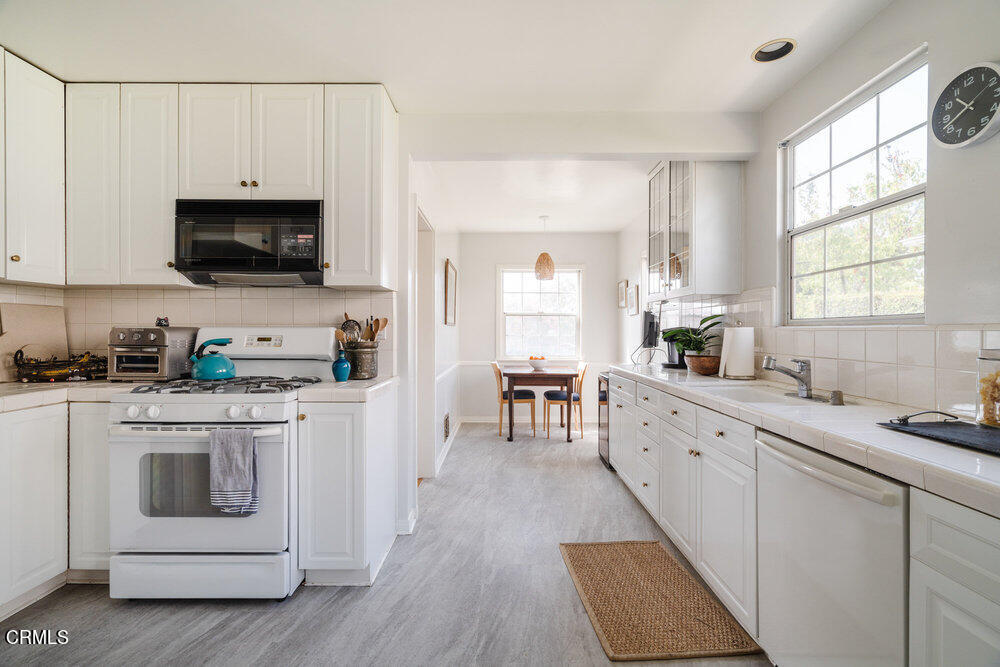 1795 Sonoma Drive Altadena, CA 91001 - Photo 9 of 29 a kitchen with white cabinets and white appliances