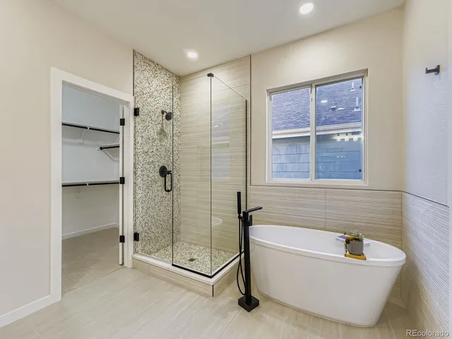 a bathroom with a tub and shower