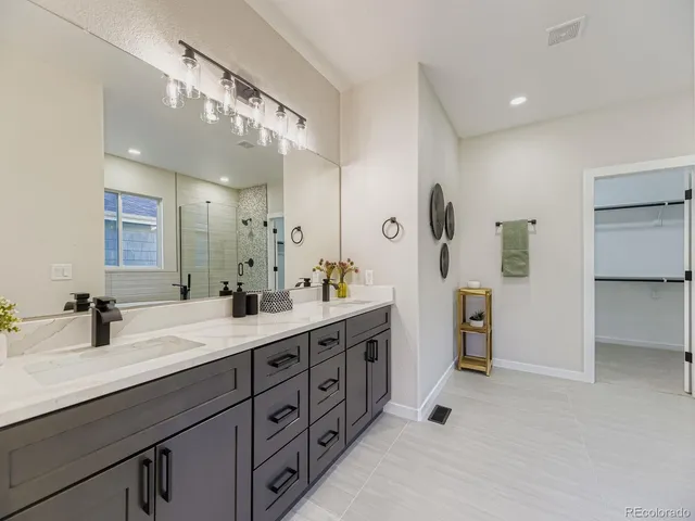 a spacious bathroom with double sink and a mirror