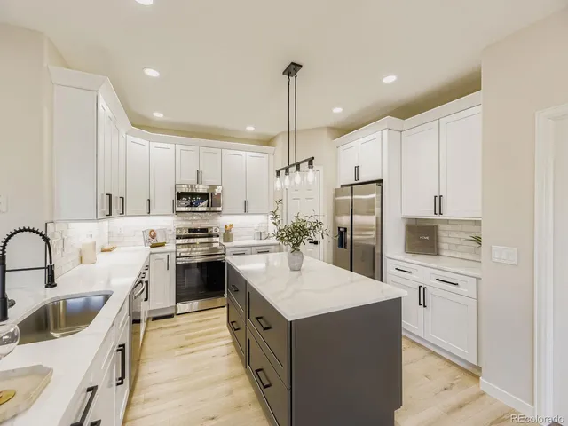 a kitchen with a sink stove and refrigerator