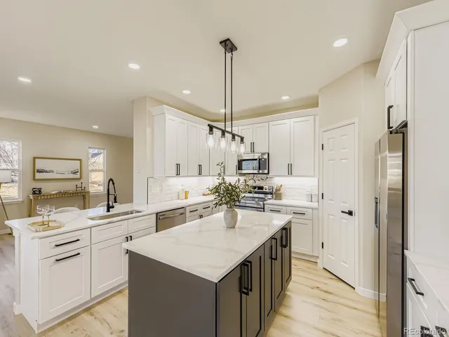 a kitchen with a sink stove and refrigerator