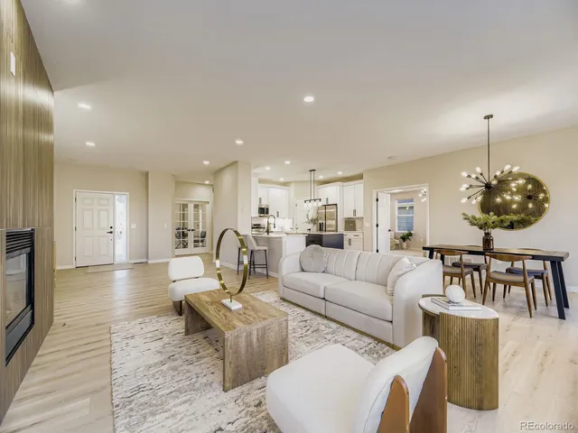 a living room with furniture a dining table and a flat screen tv