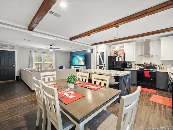 a dining room with furniture and wooden floor