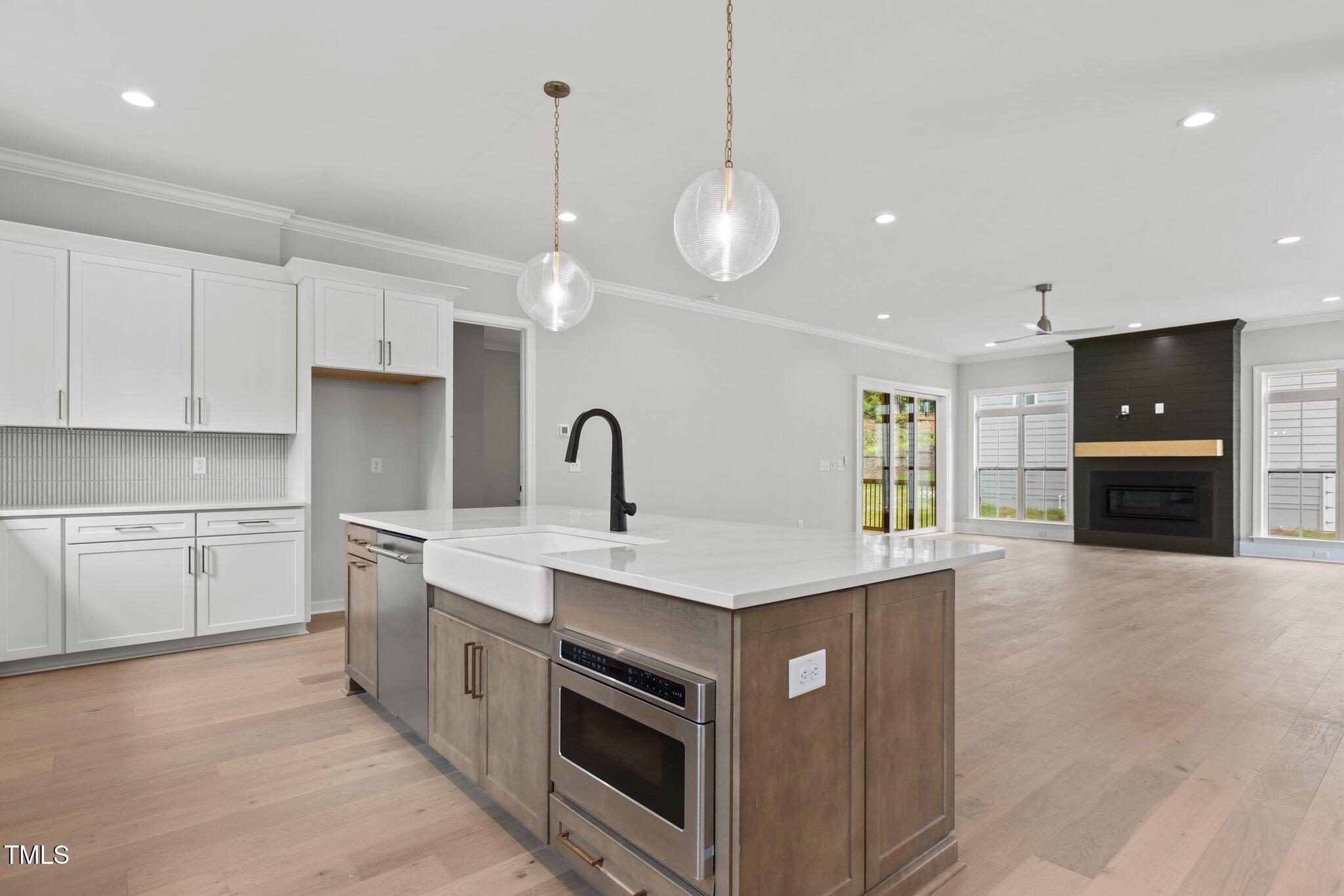 9305 Field Maple Court Raleigh, NC 27613 - Photo 4 of 13 a kitchen with a sink and a stove top oven