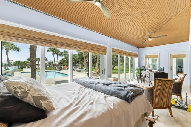 a large bedroom with a bed and large windows