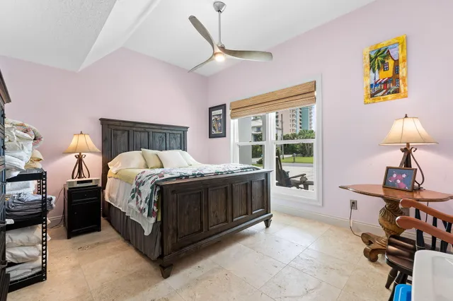 a spacious bedroom with a bed and a window