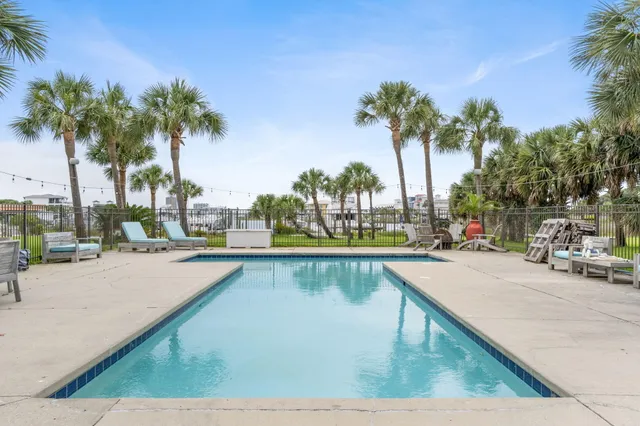 a view of swimming pool with outdoor seating and a park