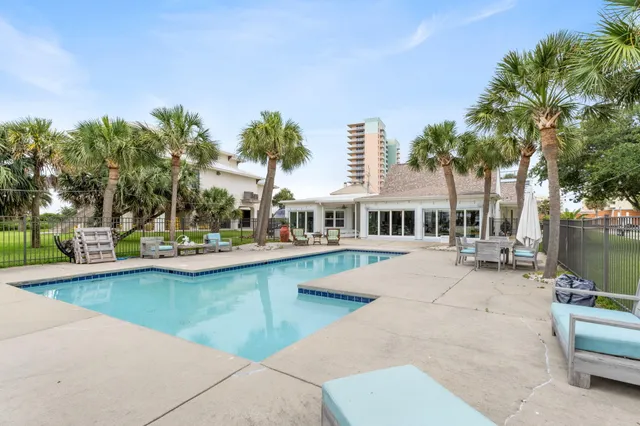 a view of a swimming pool and lounge chairs