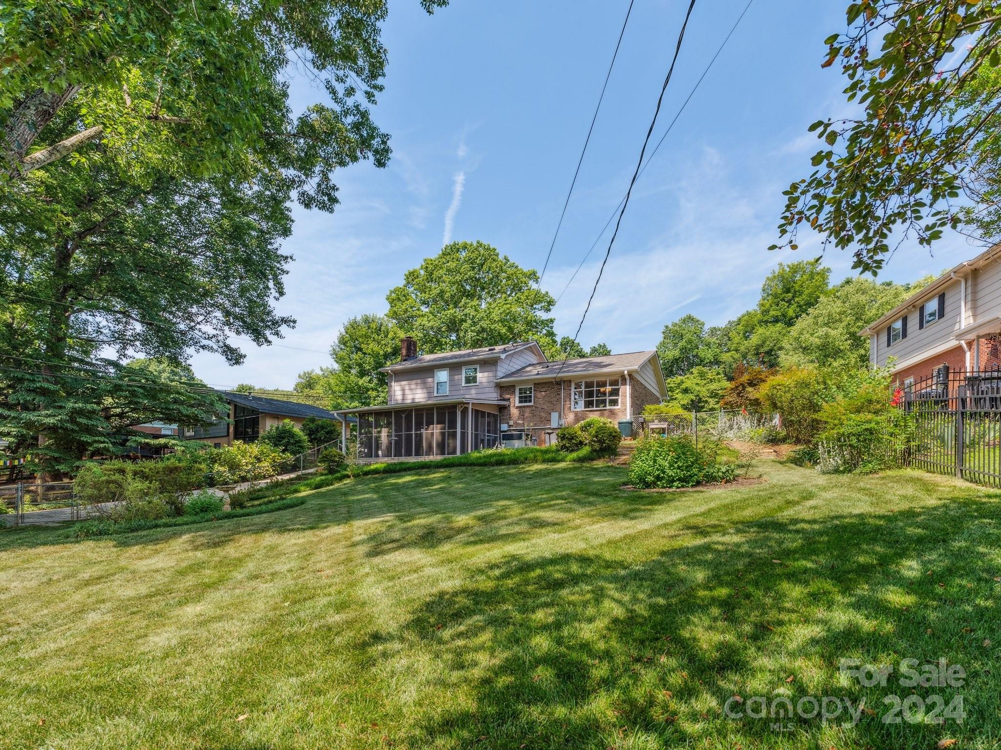 7631 Watercrest Road Charlotte, NC 28210 - Photo 35 of 42 a view of a house with a big yard potted plants and large tree