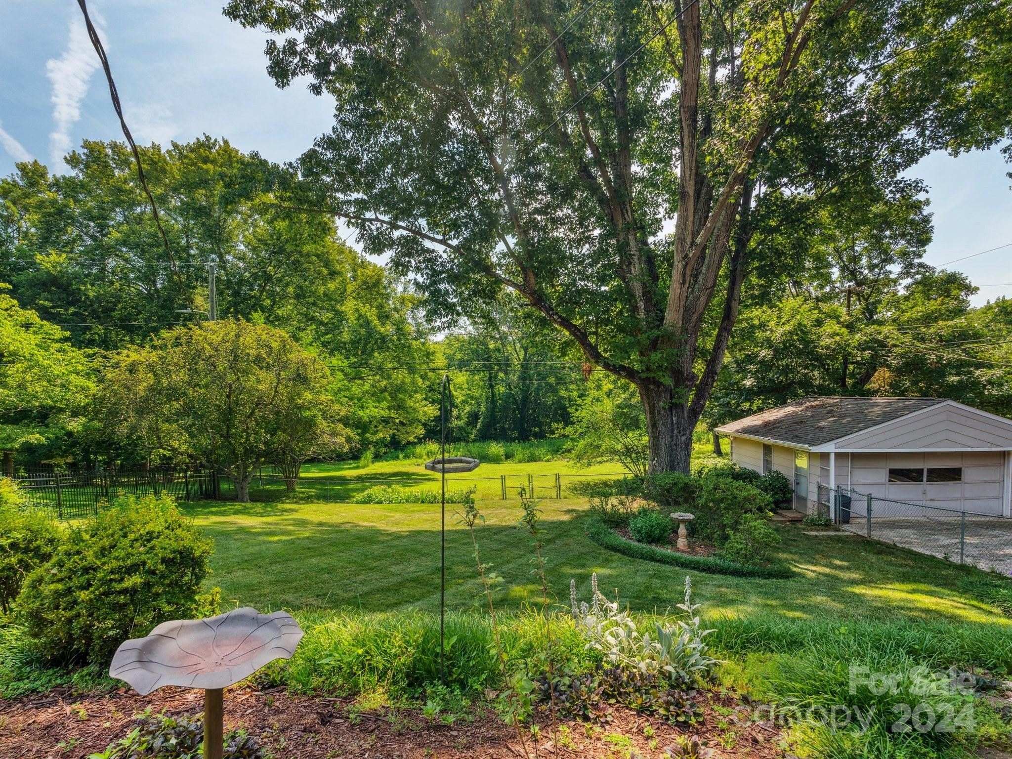 7631 Watercrest Road Charlotte, NC 28210 - Photo 36 of 42 a view of a house with swimming pool and a yard