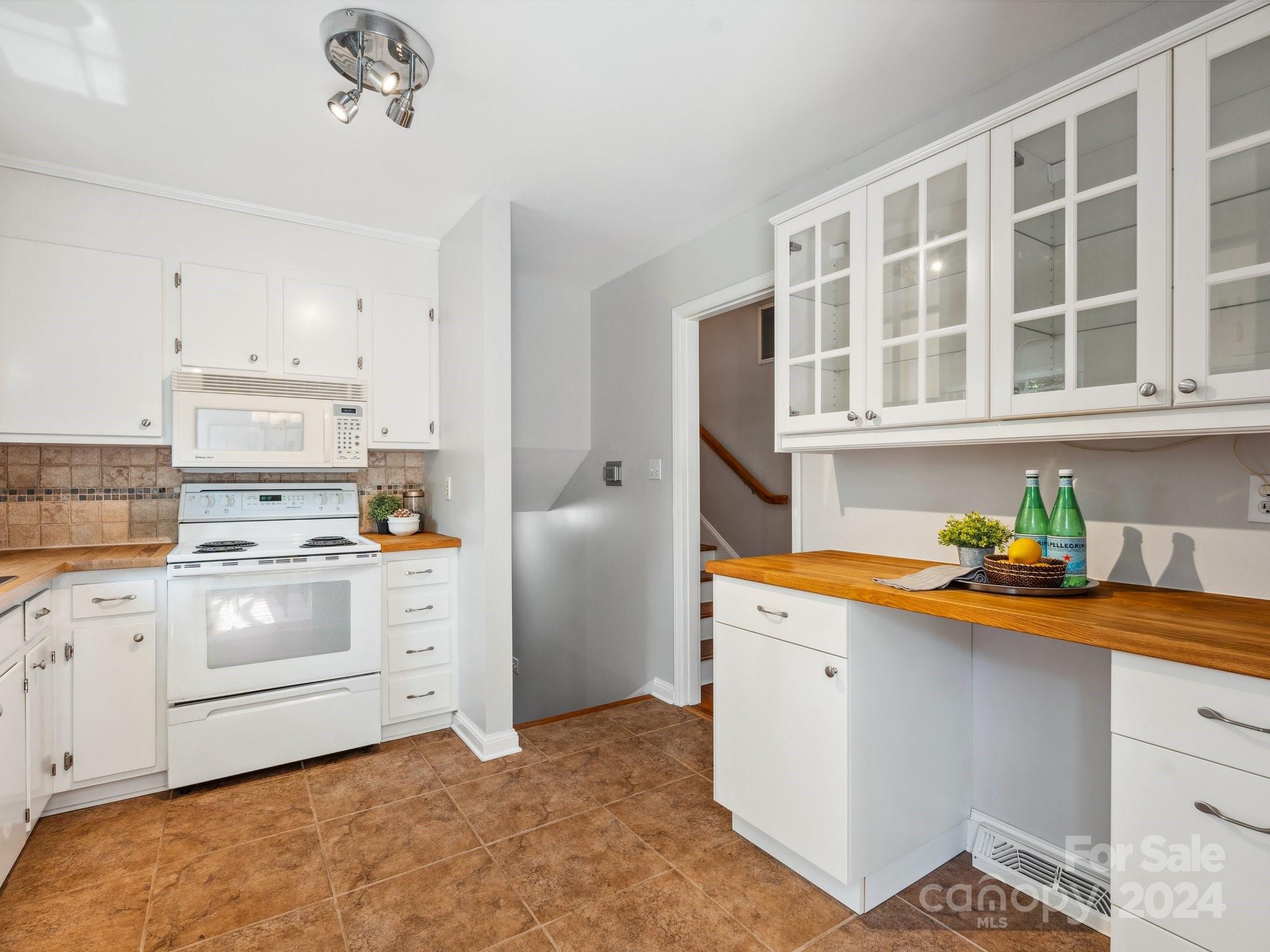 7631 Watercrest Road Charlotte, NC 28210 - Photo 8 of 42 a kitchen with stainless steel appliances cabinets and a window