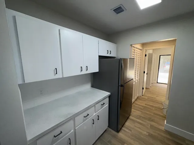 a bathroom with a sink vanity and mirror