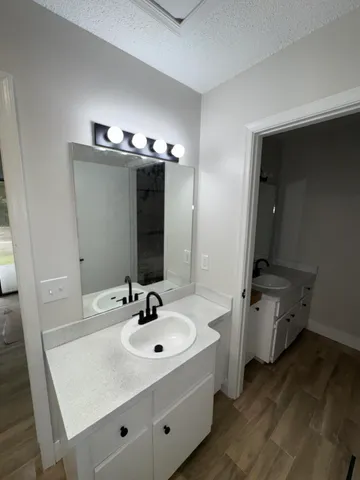 a white toilet sitting next to a bathroom sink and a shower