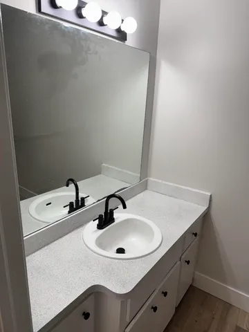 a view of an empty room and wooden floor