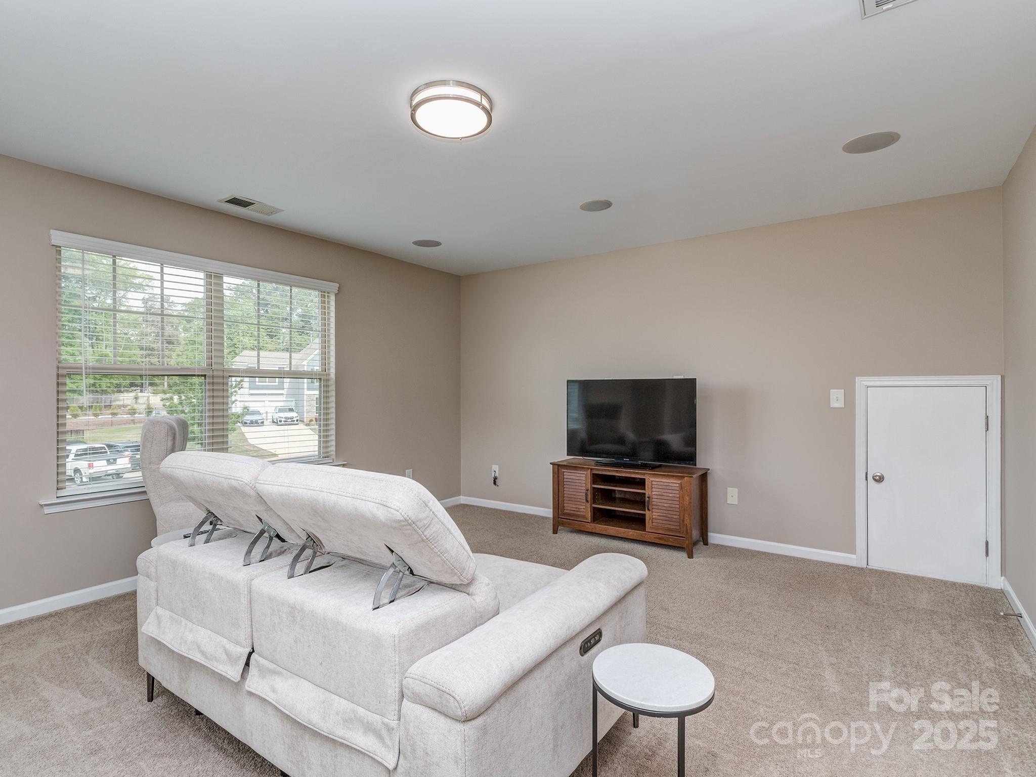 140 Halifax Drive Fort Mill, SC 29707 - Photo 19 of 38 a living room with furniture a flat screen tv and a large window