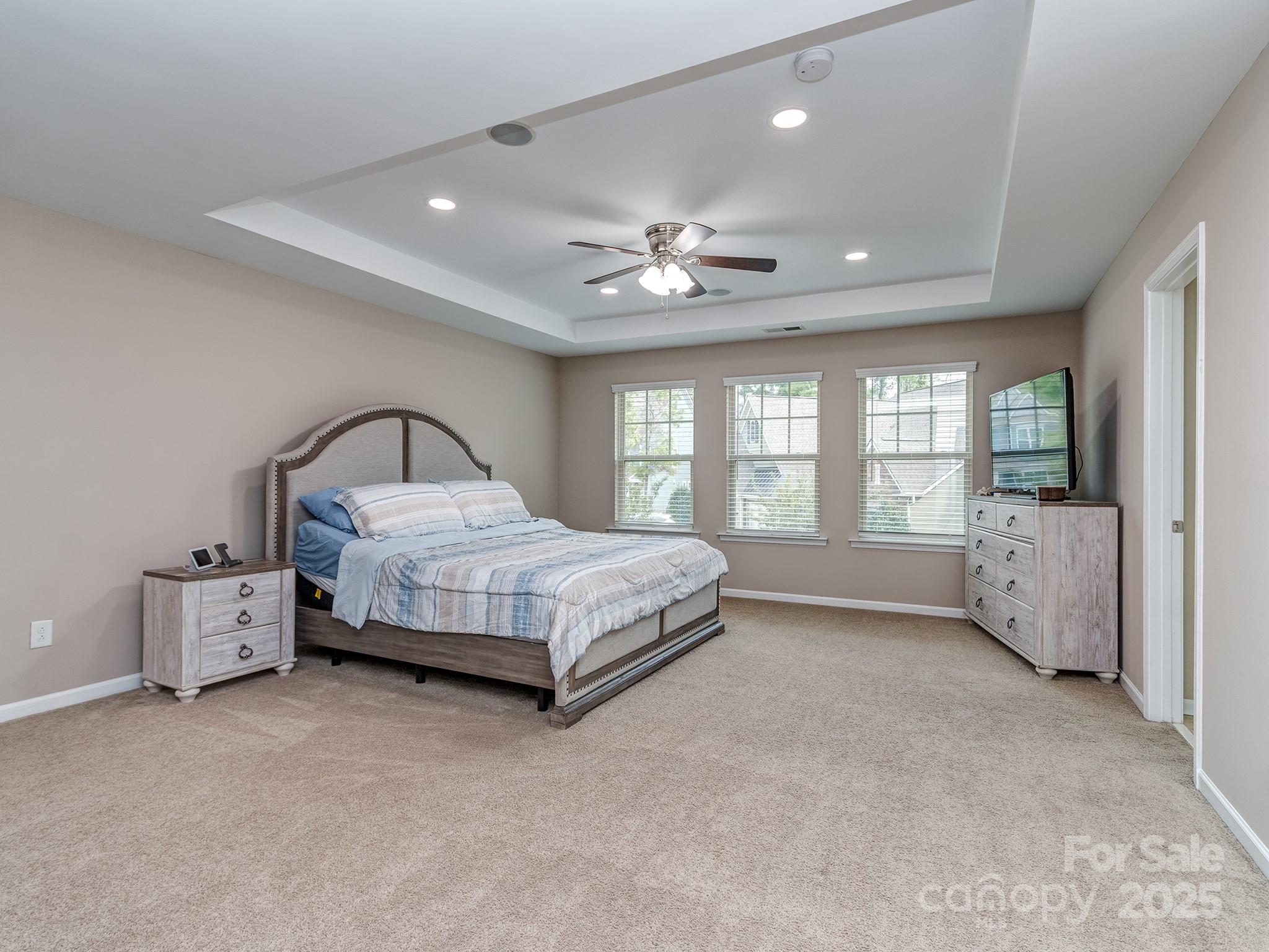 140 Halifax Drive Fort Mill, SC 29707 - Photo 27 of 38 a bedroom with a large bed and a chandelier