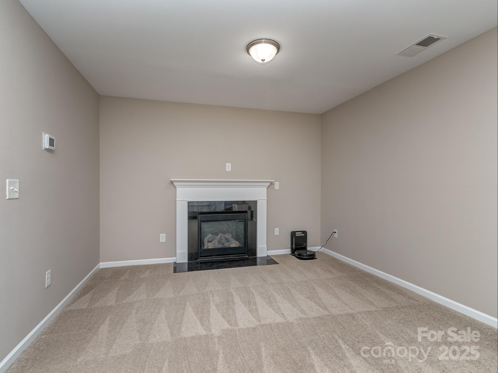 140 Halifax Drive Fort Mill, SC 29707 - Photo 28 of 38 a view of an empty room with a fireplace and a window
