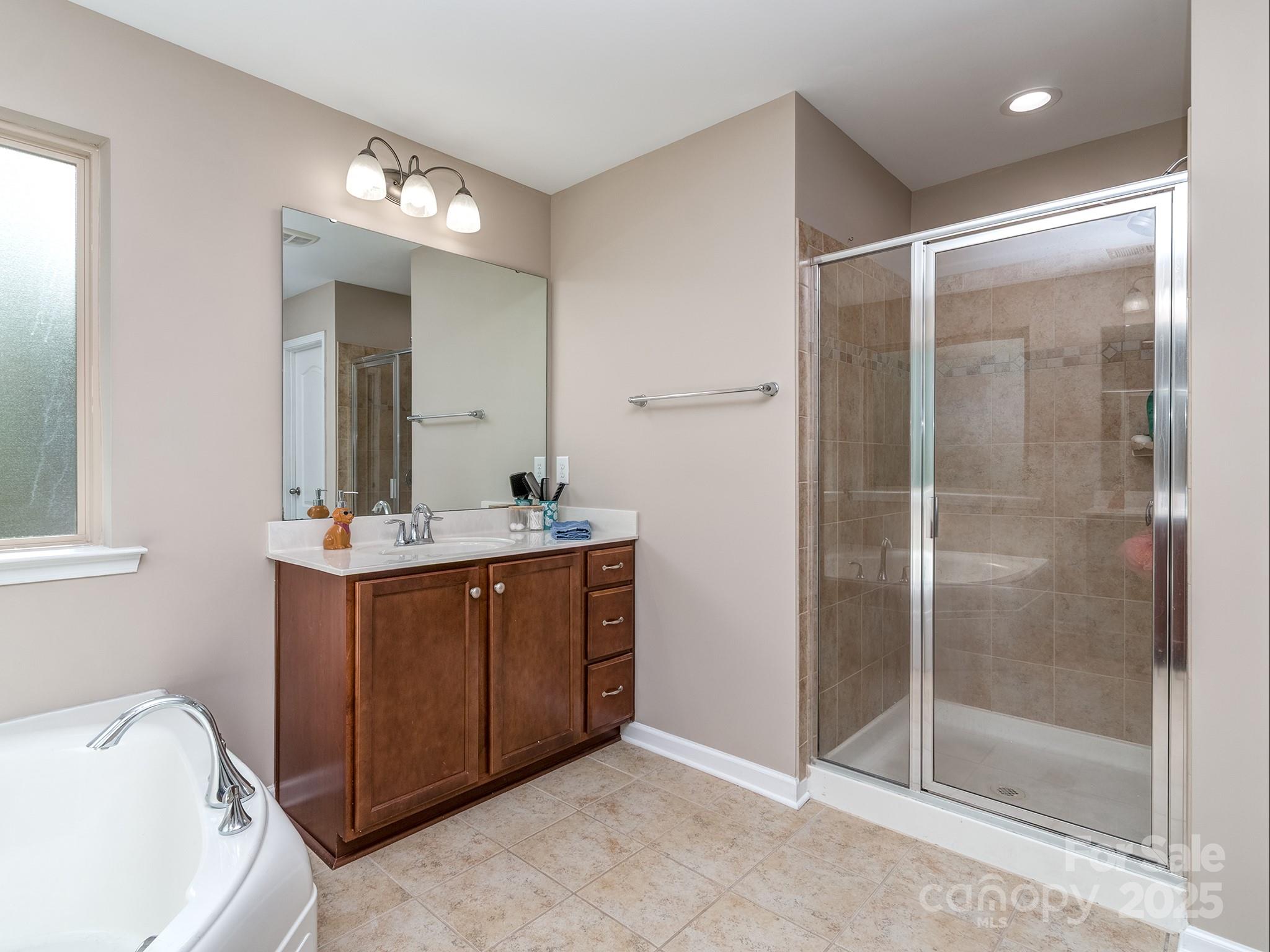 140 Halifax Drive Fort Mill, SC 29707 - Photo 30 of 38 a bathroom with a shower sink and mirror