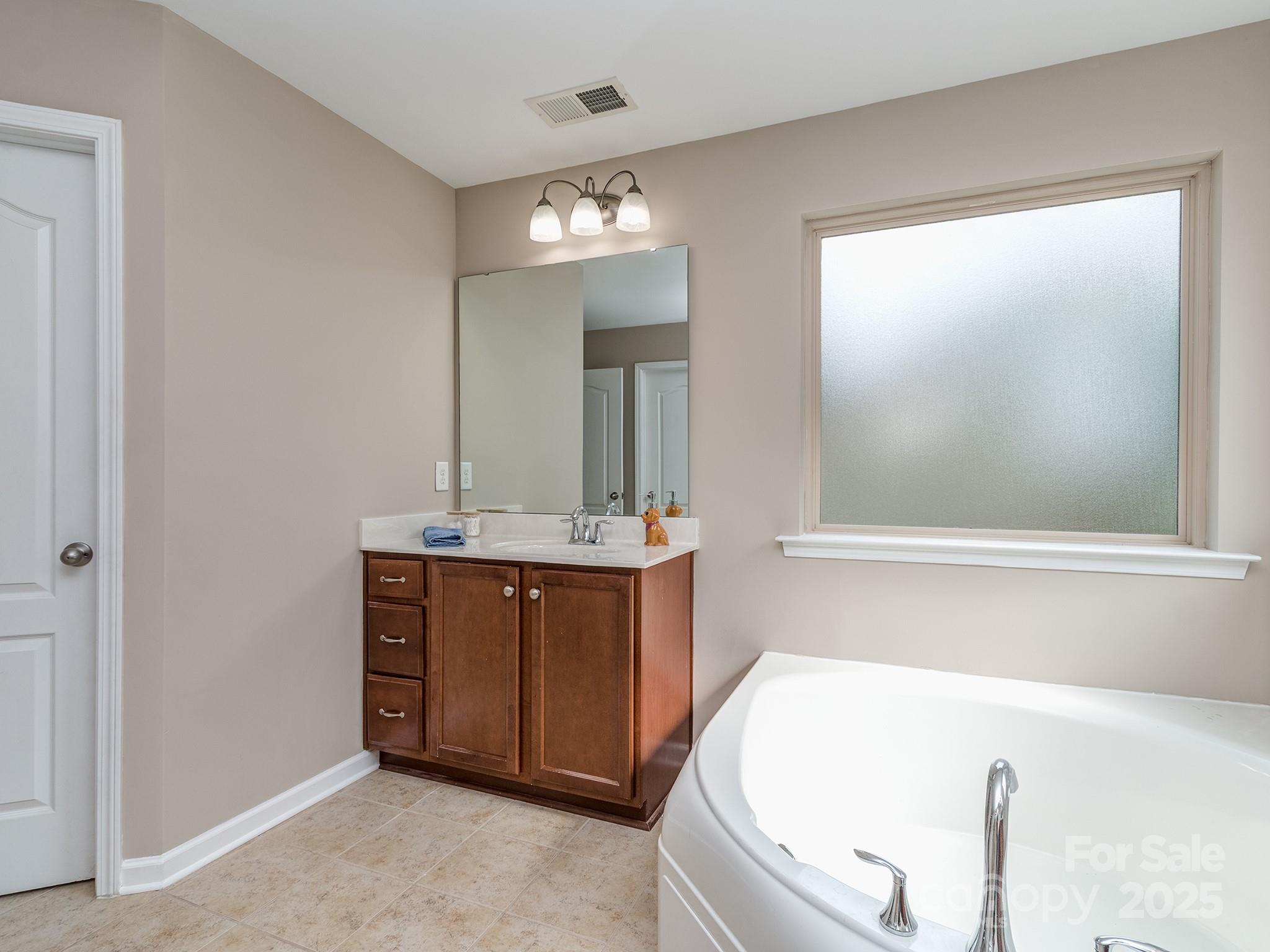 140 Halifax Drive Fort Mill, SC 29707 - Photo 31 of 38 a bathroom with a bathtub sink and mirror