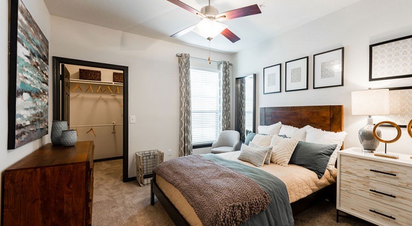 1930 Kingsley Drive, Unit 2214 Pearland, TX 77584 - Photo 1 of 6 a bedroom with a bed a dresser and with closet