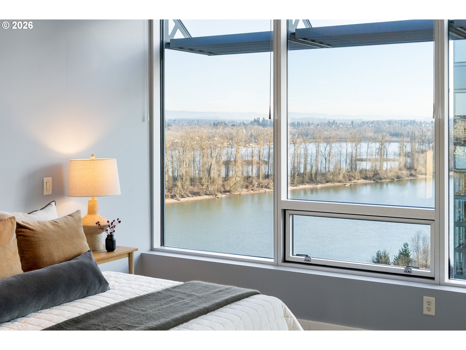 836 South Curry Street, Unit 1304 Portland, OR 97239 - Photo 18 of 34 a bedroom with a large bed and a night stand