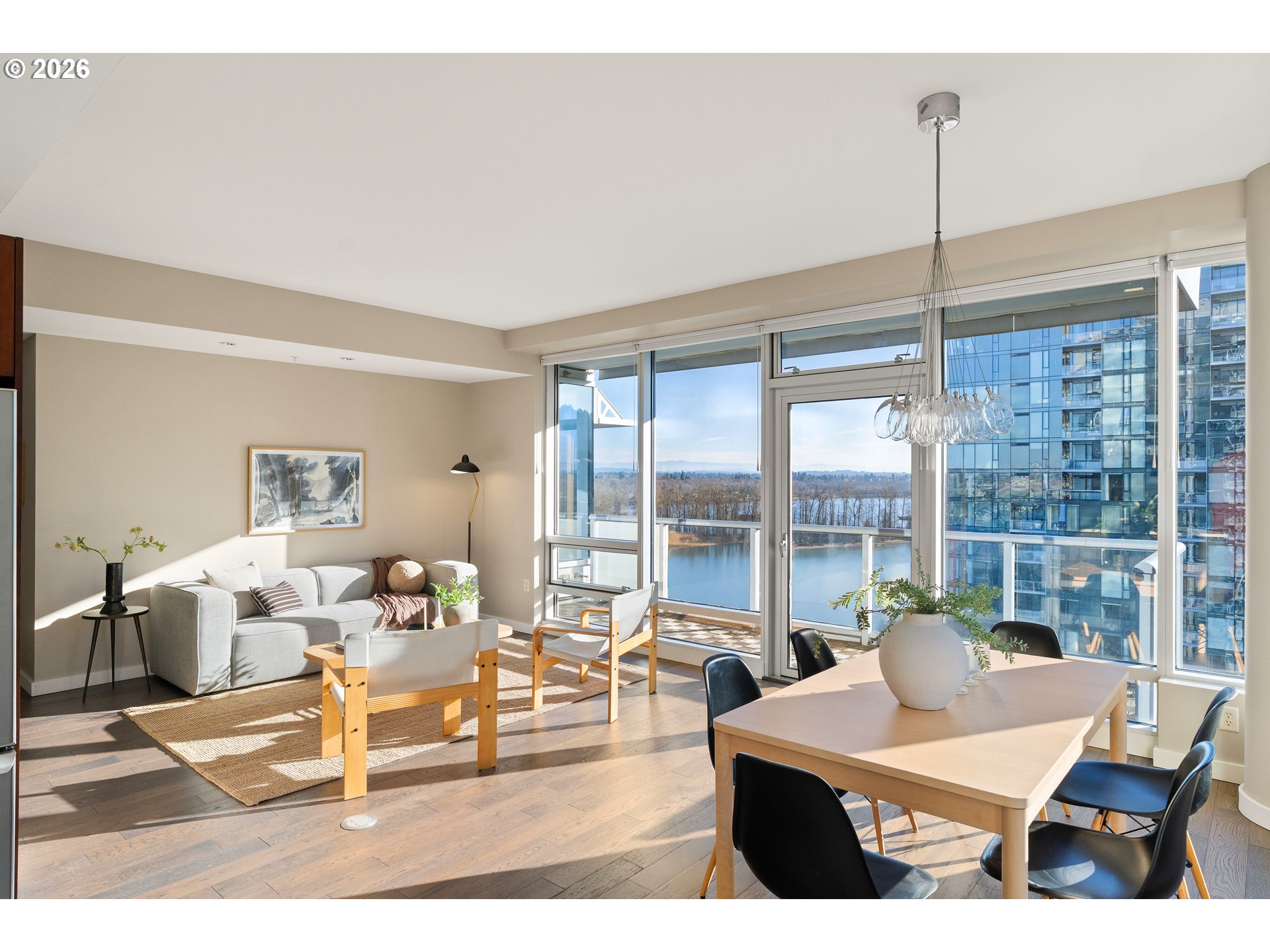 836 South Curry Street, Unit 1304 Portland, OR 97239 - Photo 2 of 34 a living room with furniture a large window and dining table
